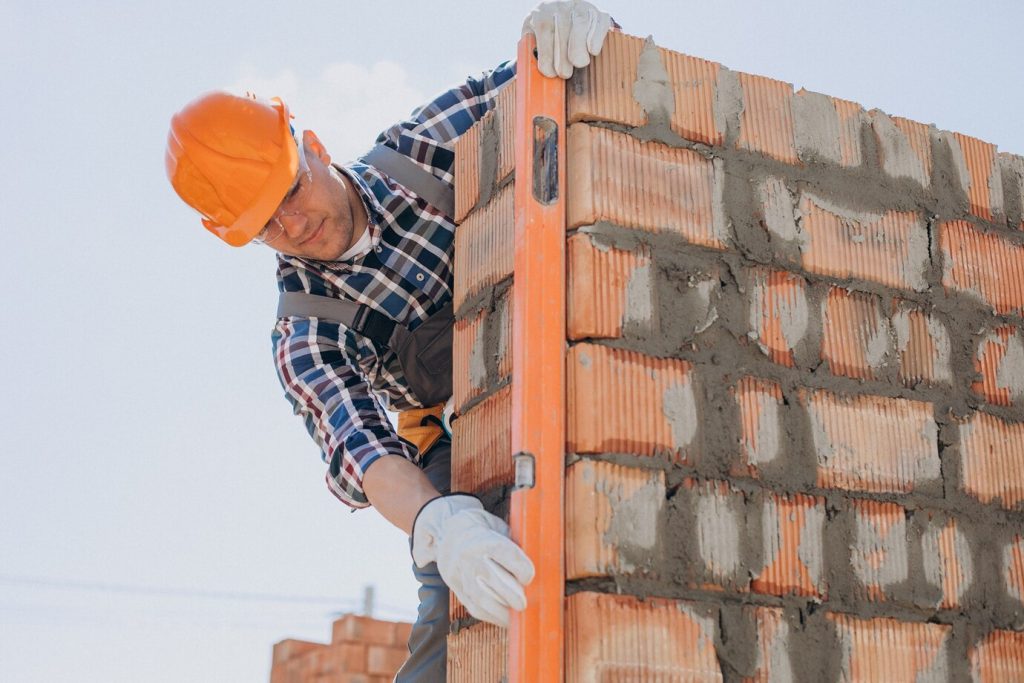 brick construction worker with level